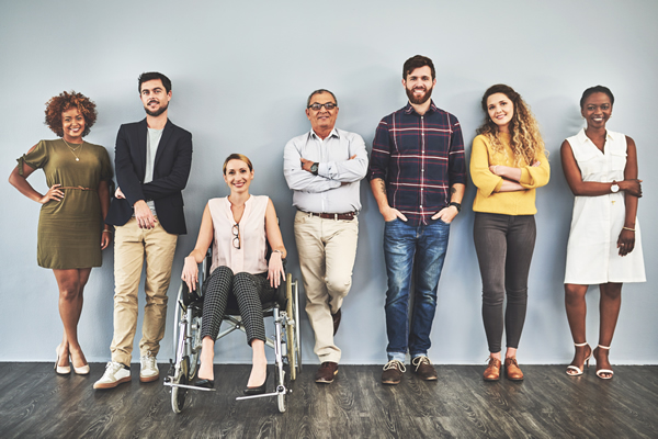a diverse group of seven people with one in a wheelchair